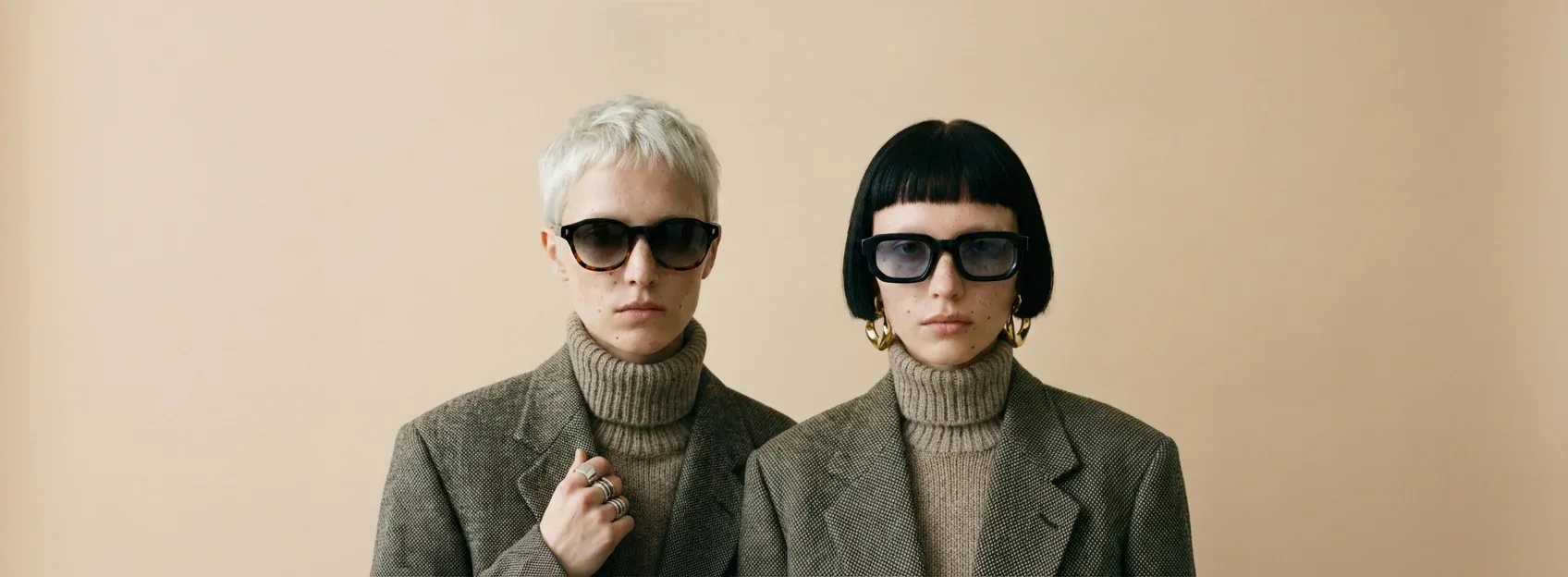 Two models wearing Three Hippos acetate and PC sunglasses from the current collection
